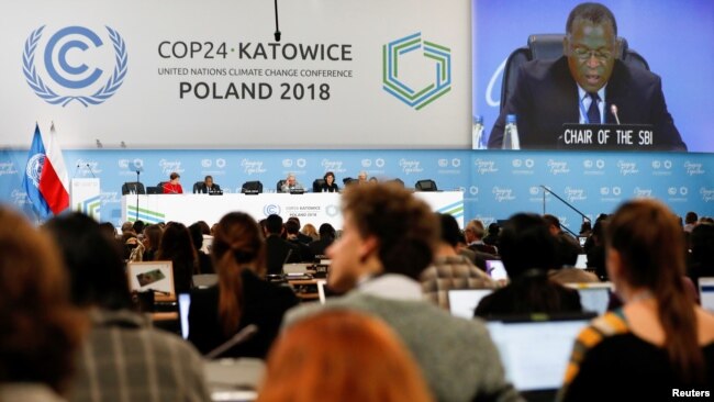 FILE - Participants take part in plenary session during COP24 U.N. Climate Change Conference 2018 in Katowice, Poland, Dec. 13, 2018.