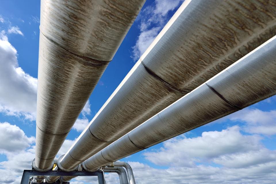Three pipeline reflecting blue sky.